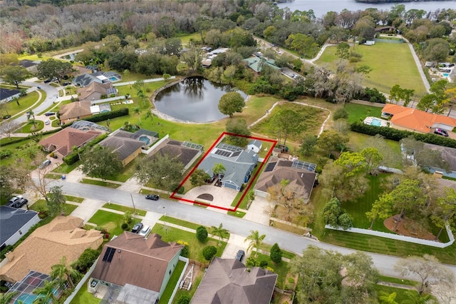 birds eye view of property with a water view and a residential view