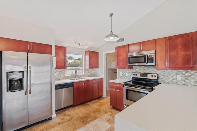 kitchen with a sink, visible vents, hanging light fixtures, appliances with stainless steel finishes, and light countertops