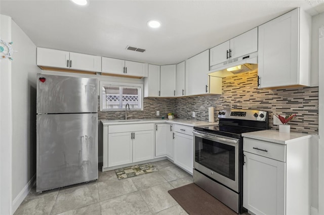 kitchen featuring stainless steel appliances, light countertops, white cabinets, and under cabinet range hood