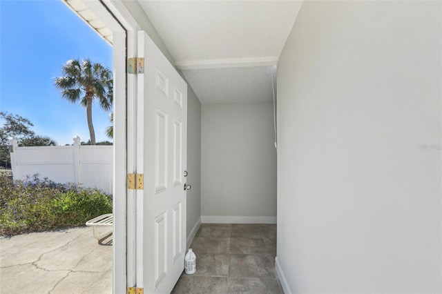 hallway featuring baseboards