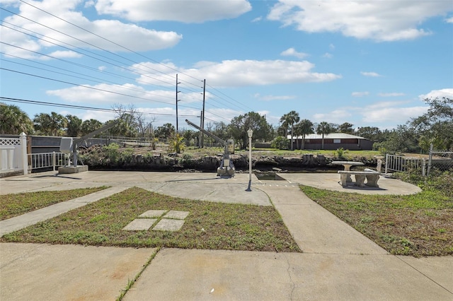 view of home's community featuring fence