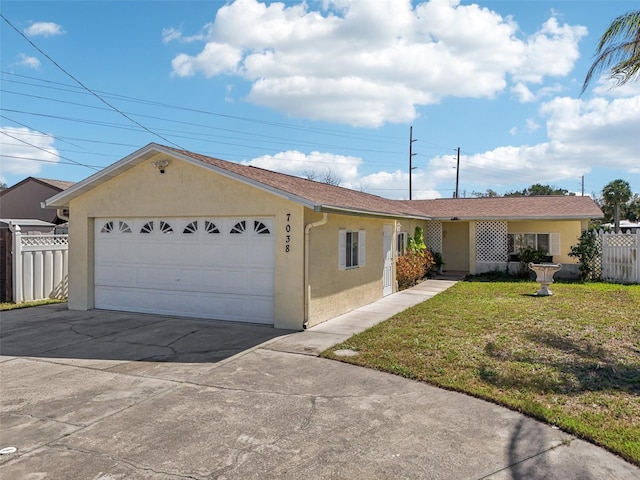 ranch-style home with an attached garage, driveway, fence, and stucco siding