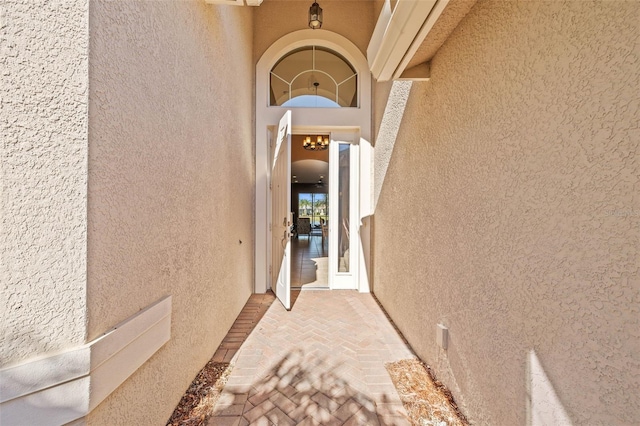 entrance to property with stucco siding