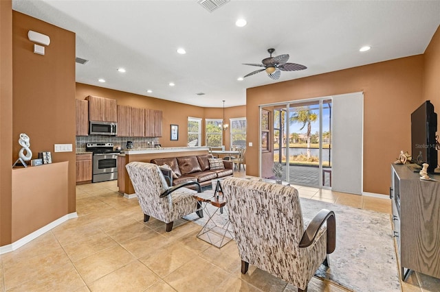 living area with light tile patterned floors, ceiling fan, visible vents, and recessed lighting