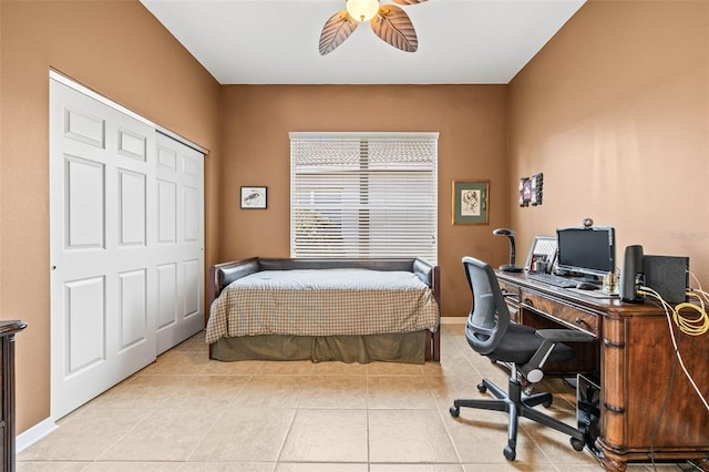 bedroom featuring light tile patterned floors, baseboards, and a ceiling fan