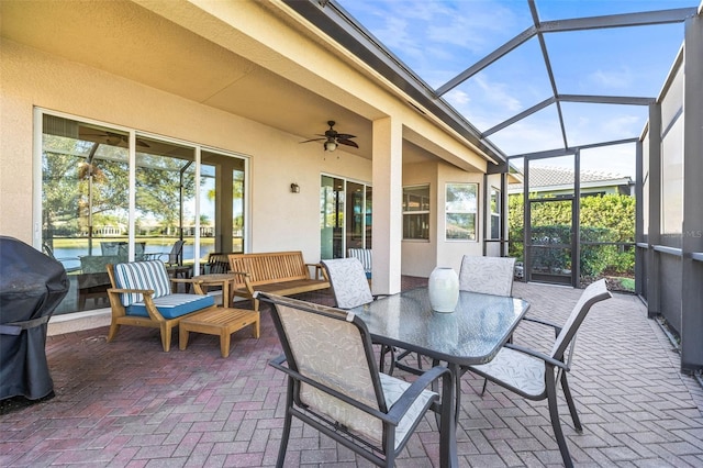 sunroom featuring a ceiling fan and a healthy amount of sunlight