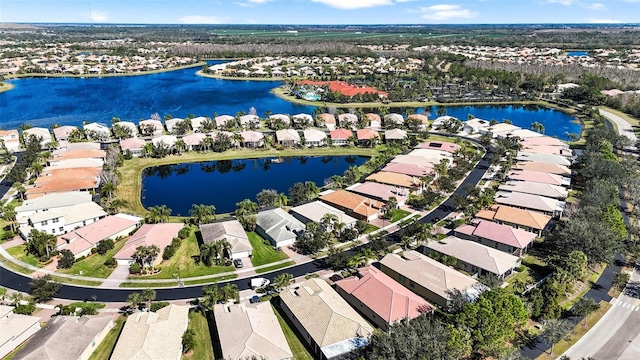 drone / aerial view featuring a water view and a residential view