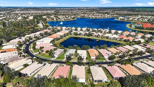 birds eye view of property with a water view and a residential view