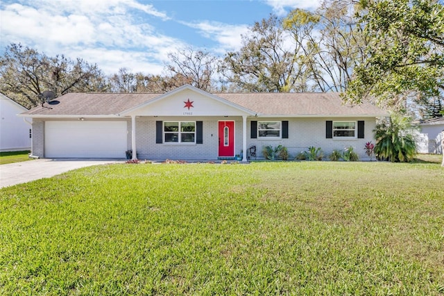 ranch-style home with concrete driveway, a front lawn, an attached garage, and brick siding