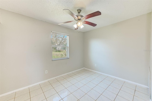 spare room featuring ceiling fan, a textured ceiling, and baseboards