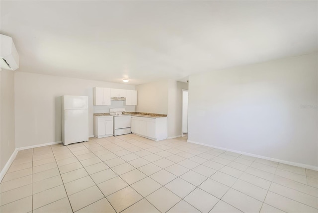 interior space with white cabinets, white appliances, a wall mounted air conditioner, under cabinet range hood, and baseboards