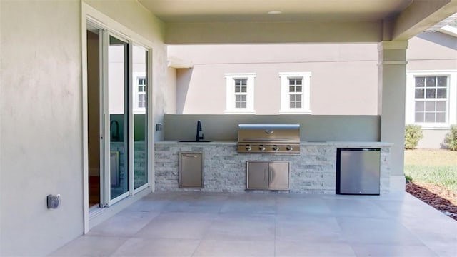 view of patio with a sink, area for grilling, and grilling area