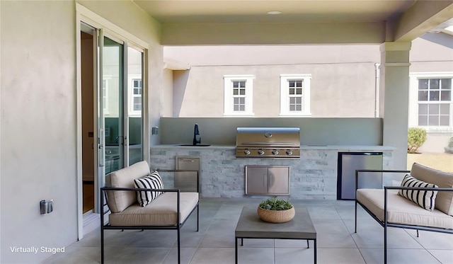 view of patio / terrace with a sink, area for grilling, and exterior kitchen