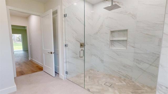 full bathroom with baseboards and a marble finish shower