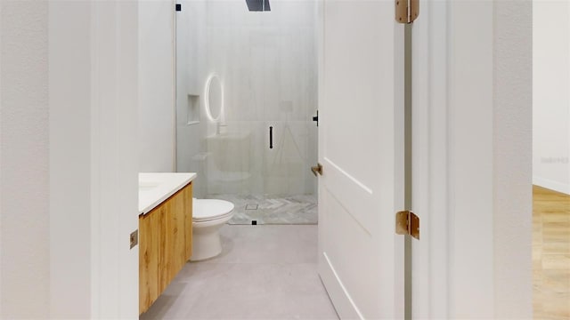 full bath with tile patterned floors, a stall shower, toilet, and vanity