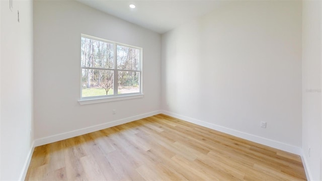 unfurnished room with recessed lighting, baseboards, and light wood finished floors