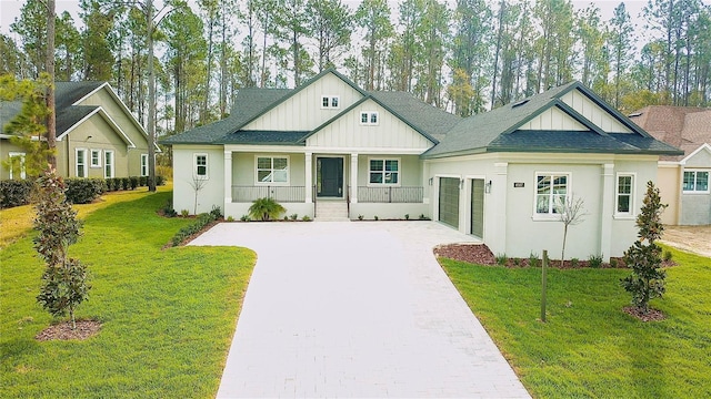 view of front of house featuring covered porch, board and batten siding, driveway, and a shingled roof