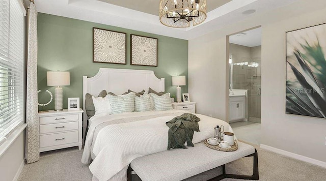 bedroom featuring baseboards, a tray ceiling, a chandelier, and light colored carpet