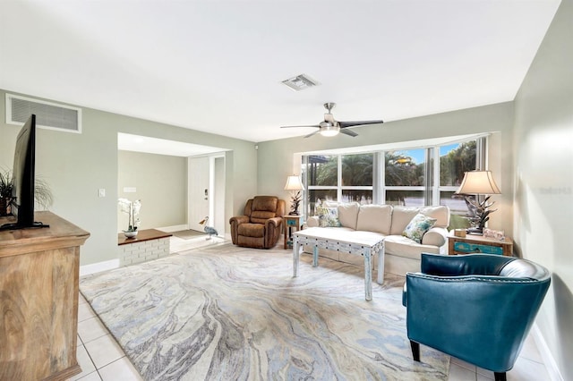 living room with visible vents, ceiling fan, baseboards, and light tile patterned floors