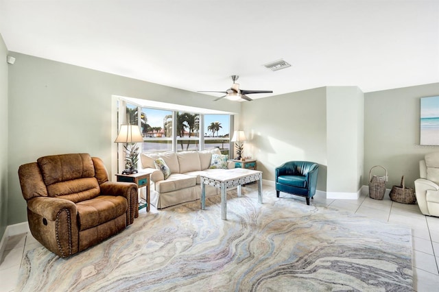 living room with ceiling fan, visible vents, baseboards, and light tile patterned flooring