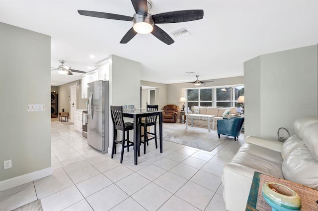 dining area featuring light tile patterned floors, visible vents, and baseboards