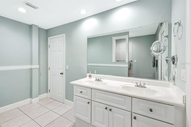 full bath with double vanity, a sink, visible vents, and tile patterned floors