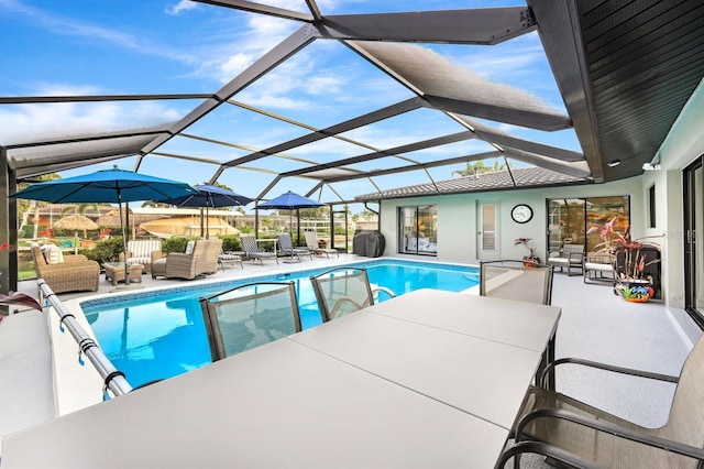 pool with a lanai, a patio area, and outdoor lounge area