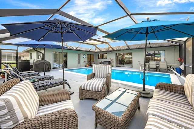 pool with outdoor lounge area, glass enclosure, a patio, and grilling area