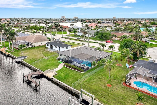 drone / aerial view with a residential view and a water view