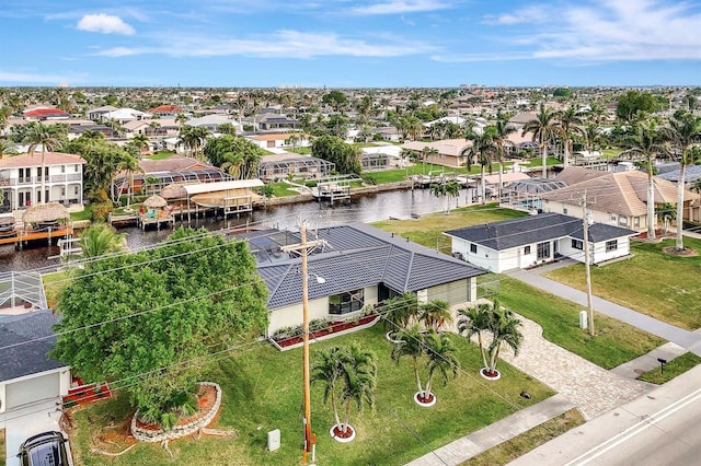 drone / aerial view with a residential view and a water view