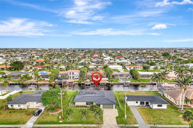 drone / aerial view featuring a water view and a residential view