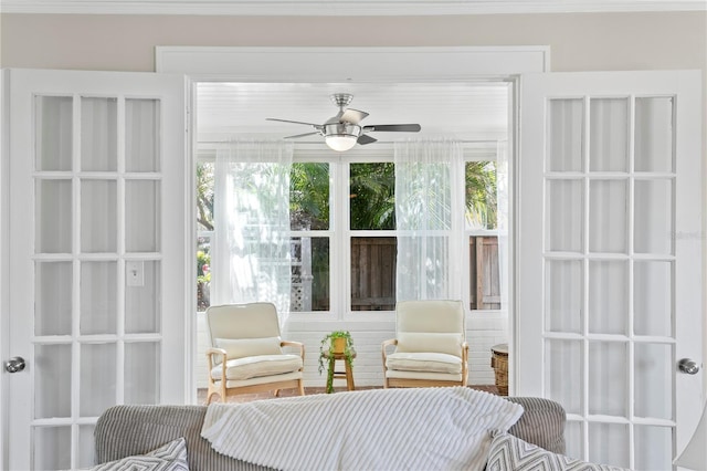 sunroom with a wealth of natural light and a ceiling fan