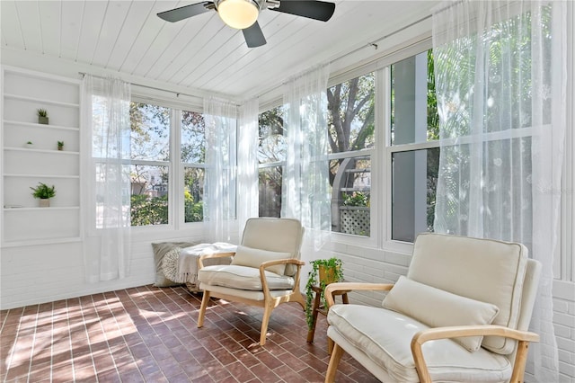 sunroom / solarium with ceiling fan and wooden ceiling