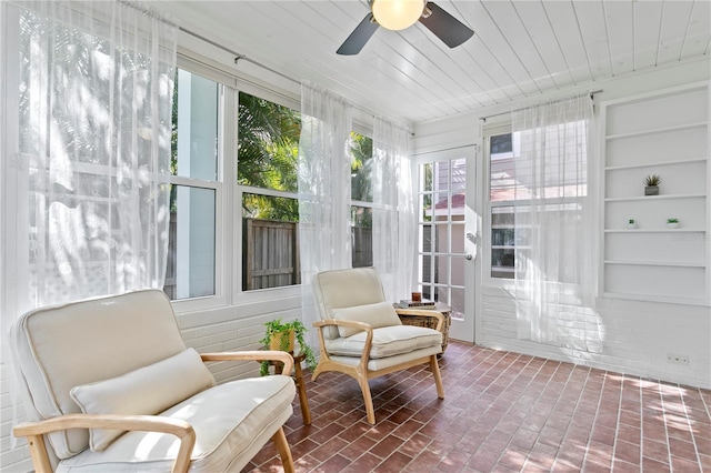 sunroom / solarium with ceiling fan and wooden ceiling