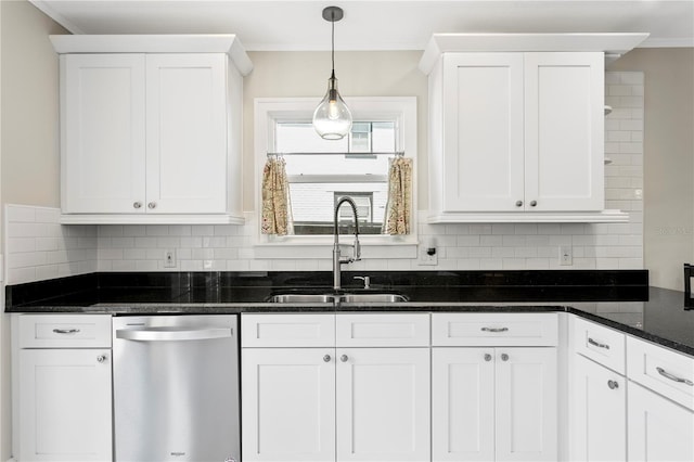 kitchen featuring dishwasher, dark stone countertops, a sink, and white cabinets