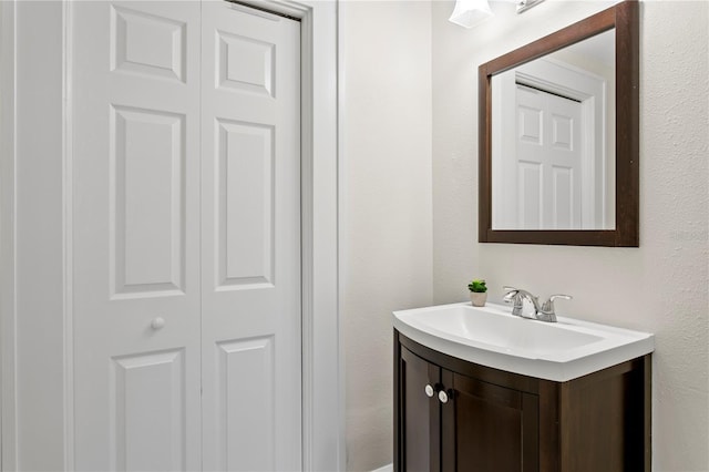 bathroom with a closet and vanity