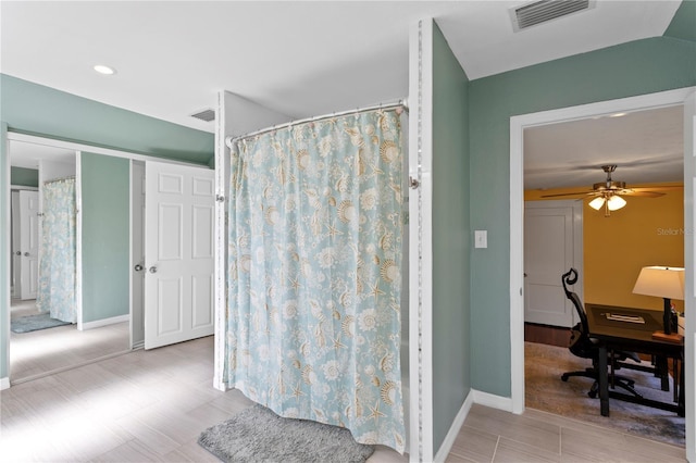 bathroom featuring a ceiling fan, visible vents, and baseboards