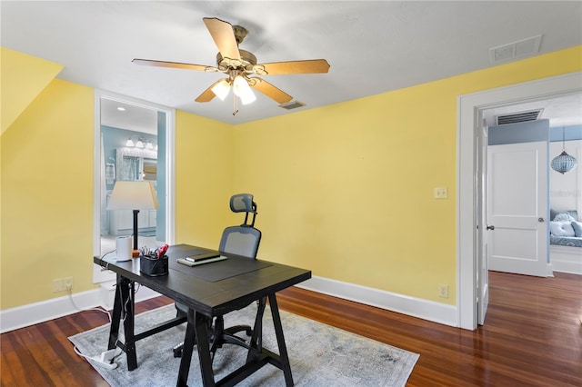 home office with dark wood-style floors, visible vents, and baseboards