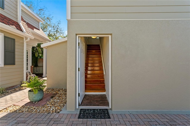 property entrance with stucco siding