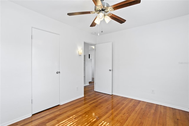 unfurnished bedroom featuring wood finished floors, a ceiling fan, and baseboards