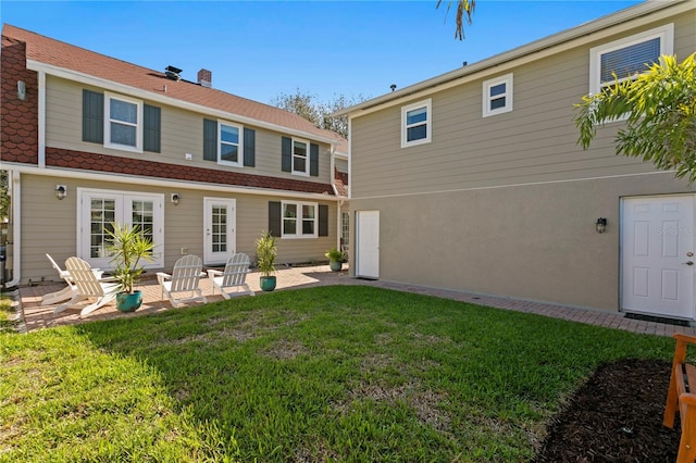 back of house featuring a patio area and a yard