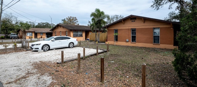 view of front of house with fence and brick siding