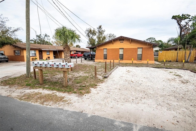 view of home's exterior featuring brick siding and fence