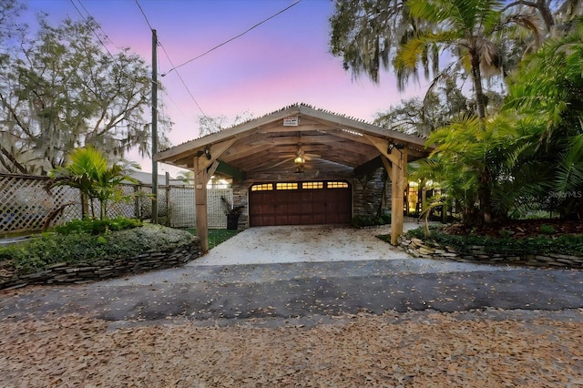 view of front of property featuring stone siding and fence