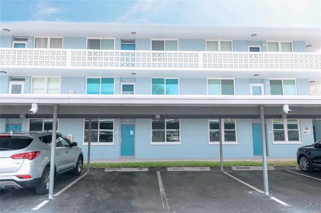 view of building exterior with covered parking