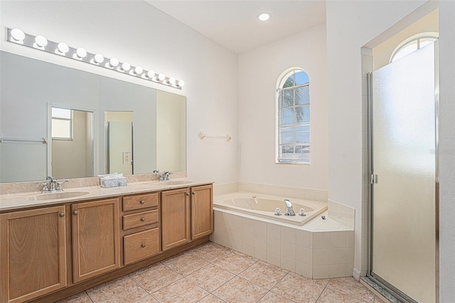 full bathroom featuring a bath, a shower stall, a sink, and tile patterned floors