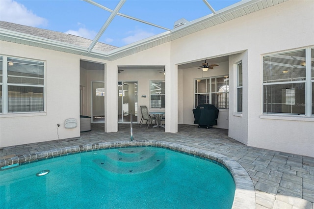 outdoor pool with a lanai, a grill, ceiling fan, and a patio