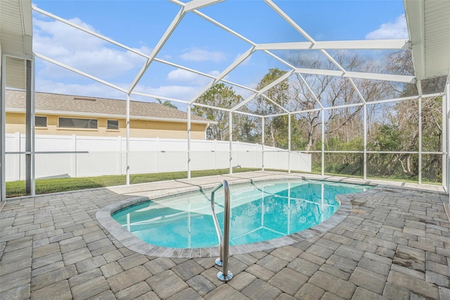 view of pool featuring a fenced in pool, a patio area, glass enclosure, and a fenced backyard