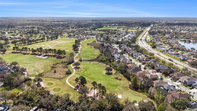 drone / aerial view featuring a residential view, a water view, and golf course view