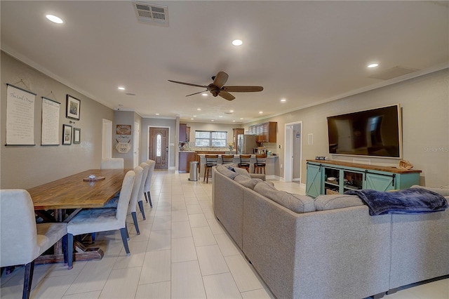 living area featuring ceiling fan, ornamental molding, visible vents, and recessed lighting